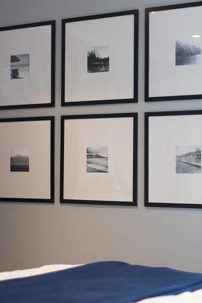 gallery wall with black frames and black and white photographs