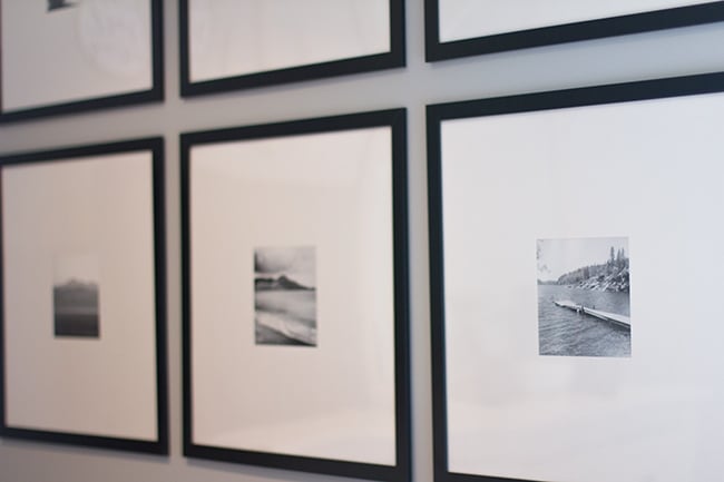 gallery wall with black frames and black and white photographs