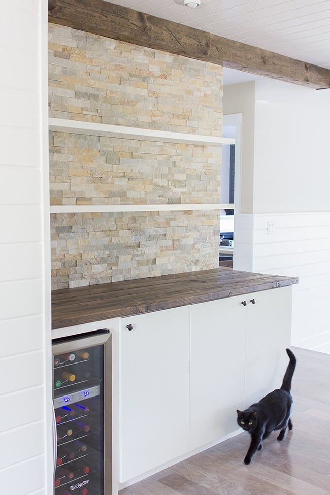 custom bar wall with stacked stone quarts and ikea cabinets