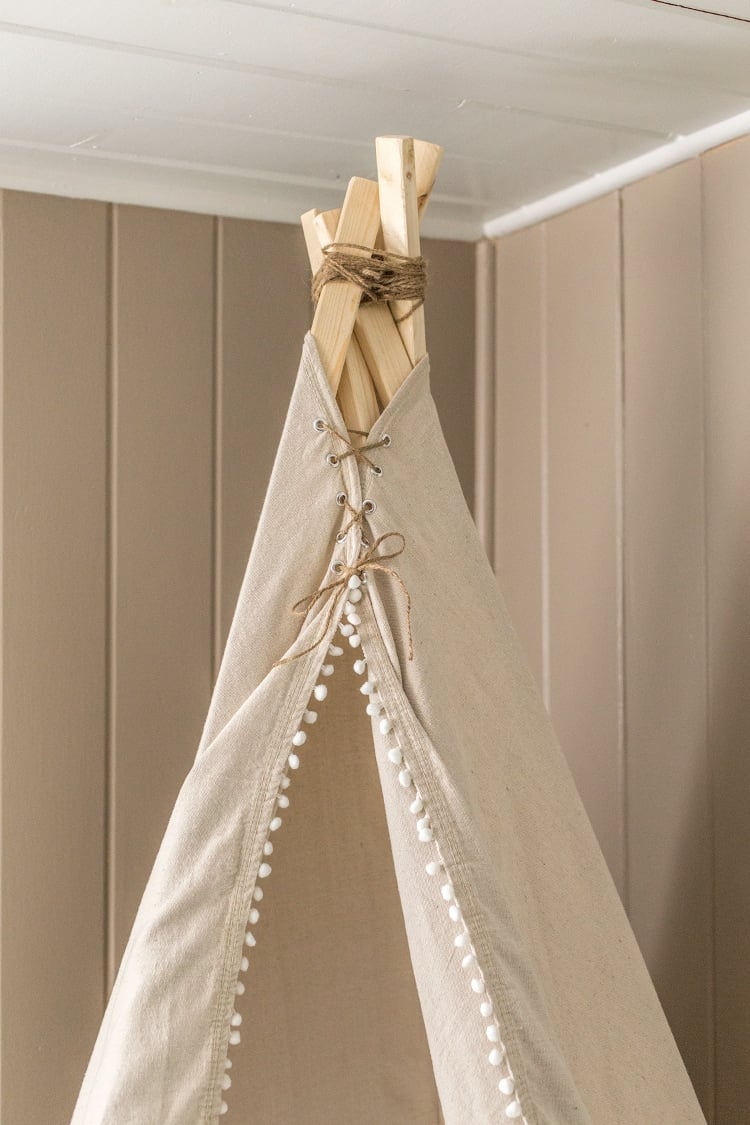 Step by step tutorial on how to make a simple, no sew dropcloth teepee for around $20!