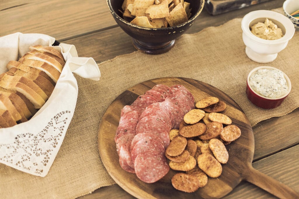 salami, cracker and bread platters on a table