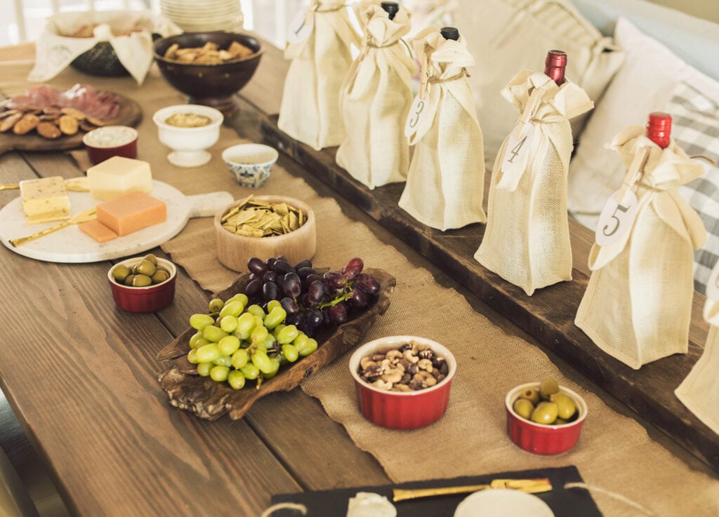 wine tasting party table spread with charcuterie board snacks