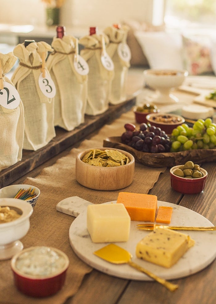 wine tasting party table spread with charcuterie board snacks