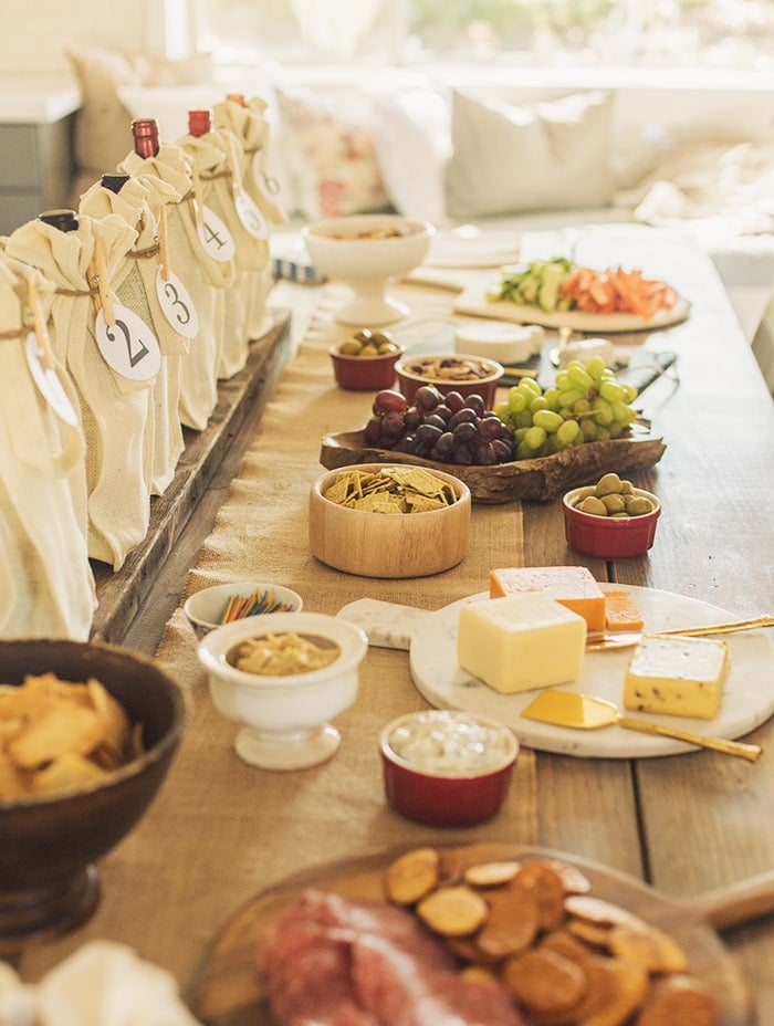 wine tasting party table spread with charcuterie board snacks