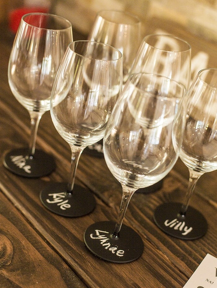 wine glasses with chalk painted bases and names written on bottom