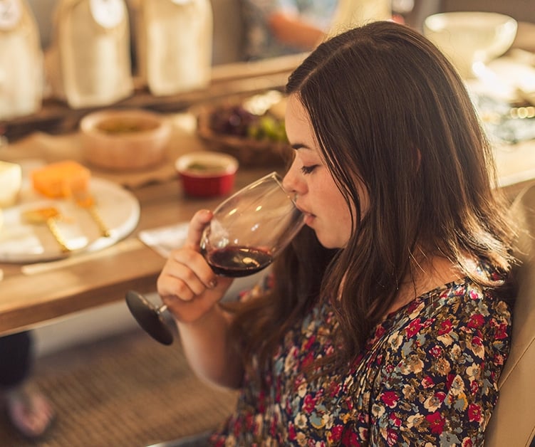 woman drinking wine at a wine tasting party