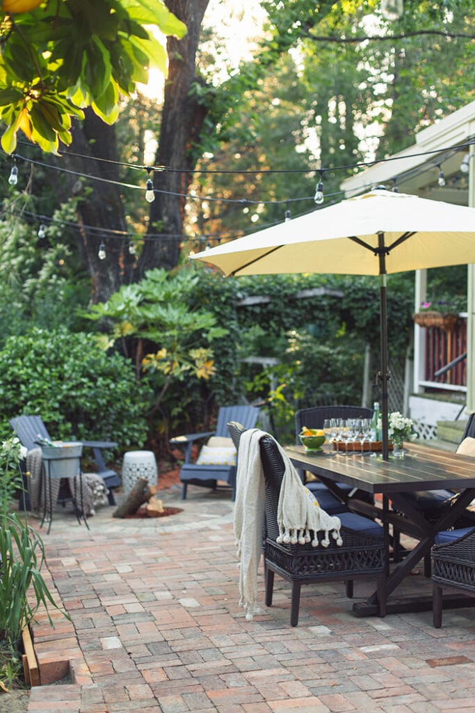 brick patio with dining set and umbrella