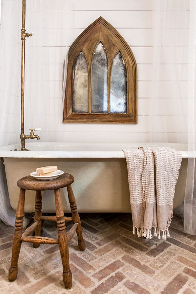 antique mirror and clawfoot bathtub