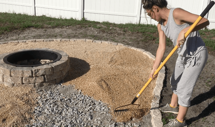 raking pea gravel in a fire pit