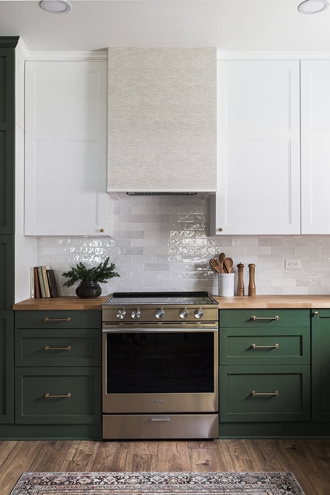 kitchen with dark green lower cabinets and white upper cabinets