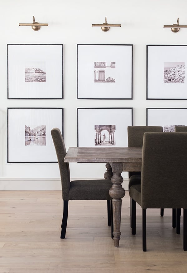 dining room with gallery wall and brass sconces