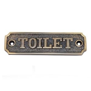 brass toilet sign