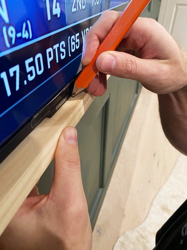 marking wood to cut a notch around a tv frame