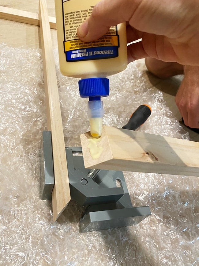 adding wood glue to corner pieces for tv frame