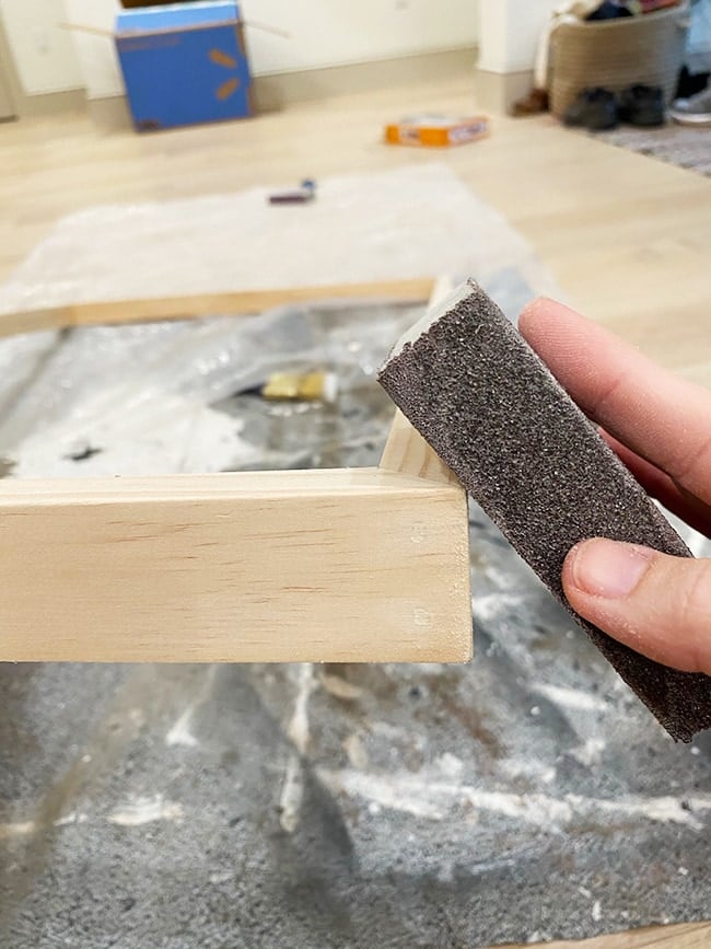 sanding the edge of a tv frame