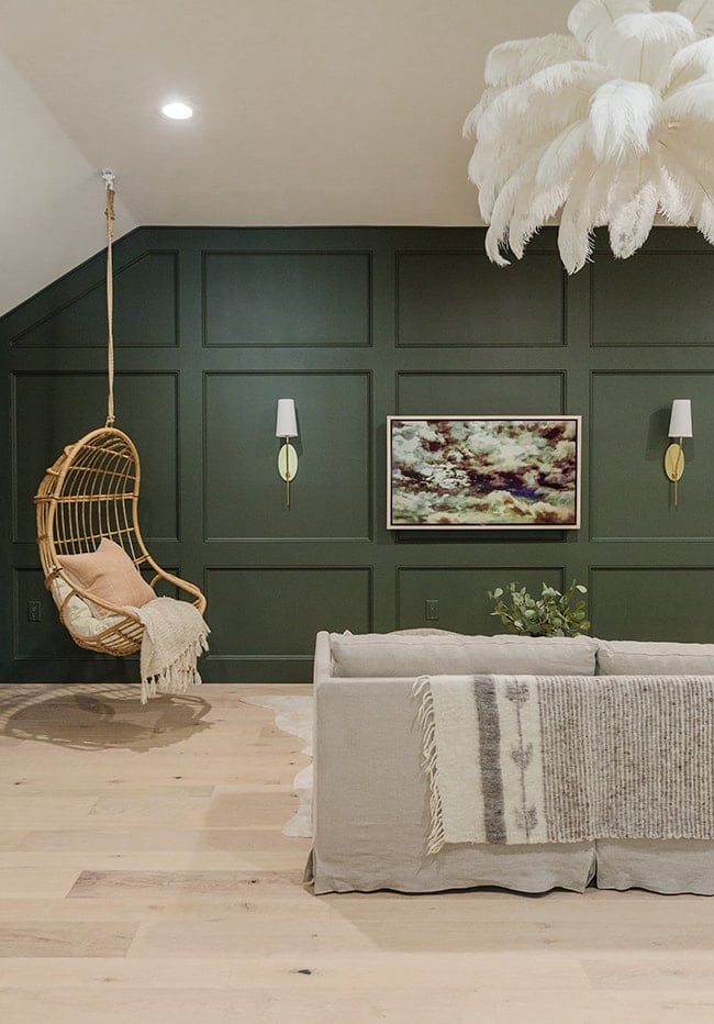 room with green wainscoting wall and diy tv frame