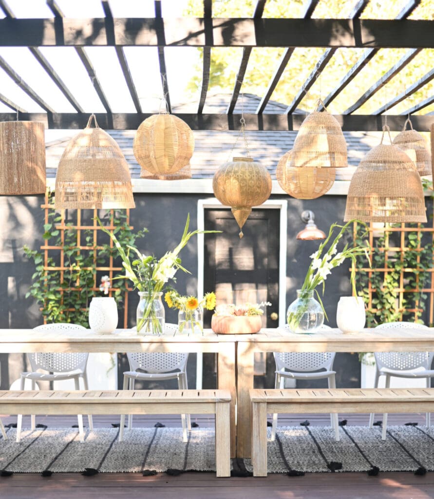 backyard dining area with hanging rattan lanterns