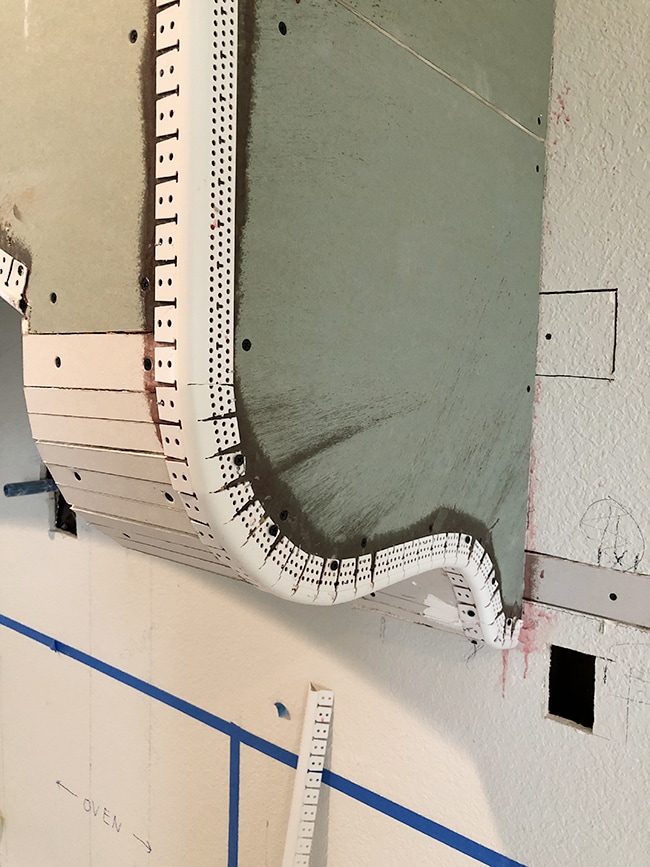 curved drywall and corner bead on a range hood