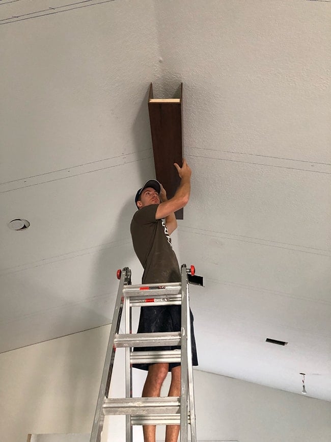 test fitting a diy ceiling beam on a vaulted ceiling
