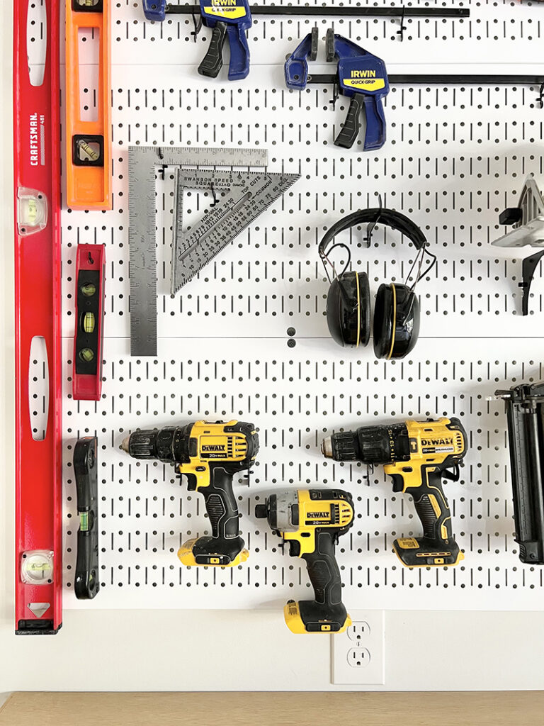 white metal pegboard and tool organization