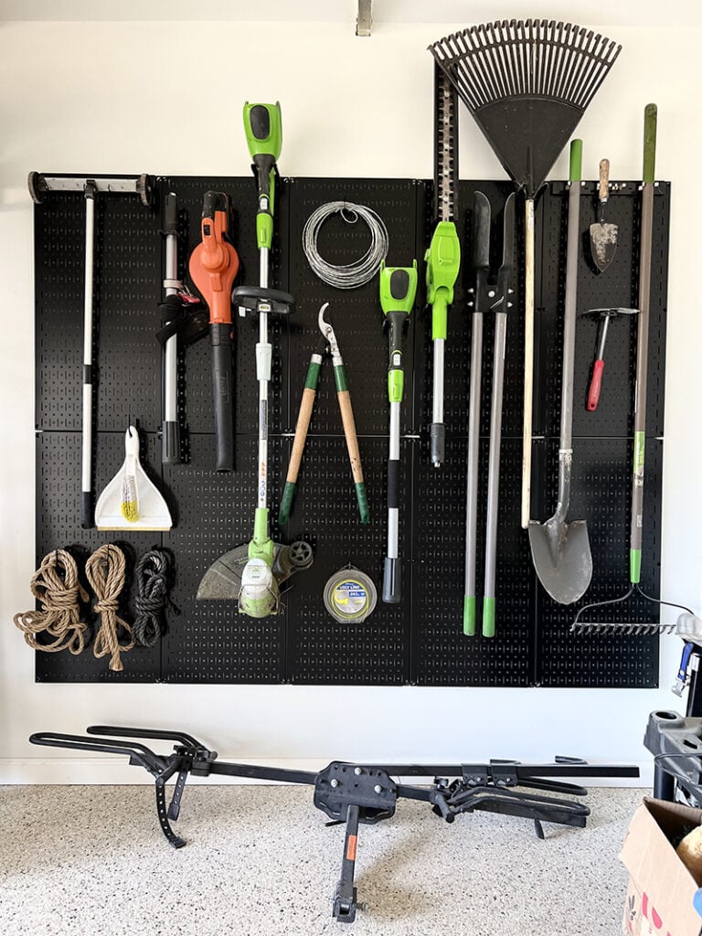 black pegboard garden tool organization