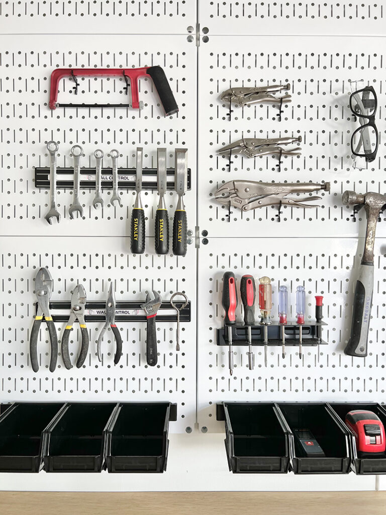 white metal pegboard and tool organization