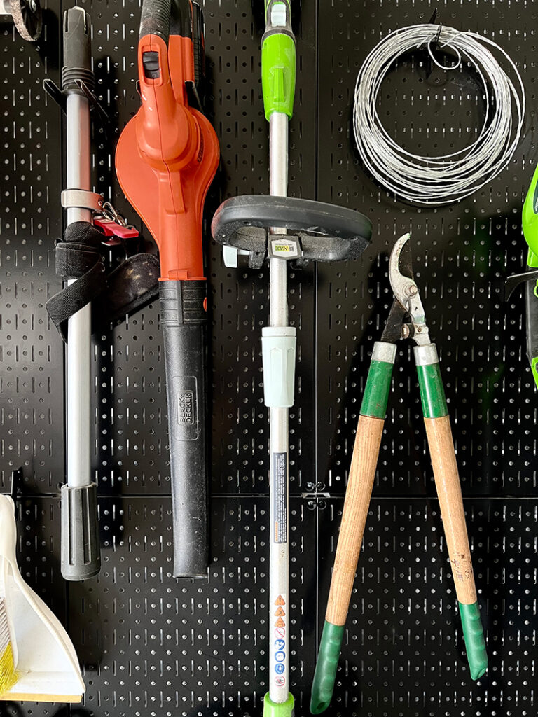 black pegboard with garden tools