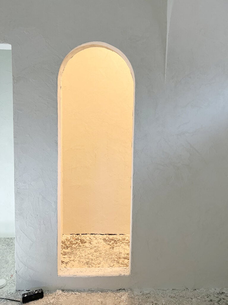 microcement bathroom with arched shower opening