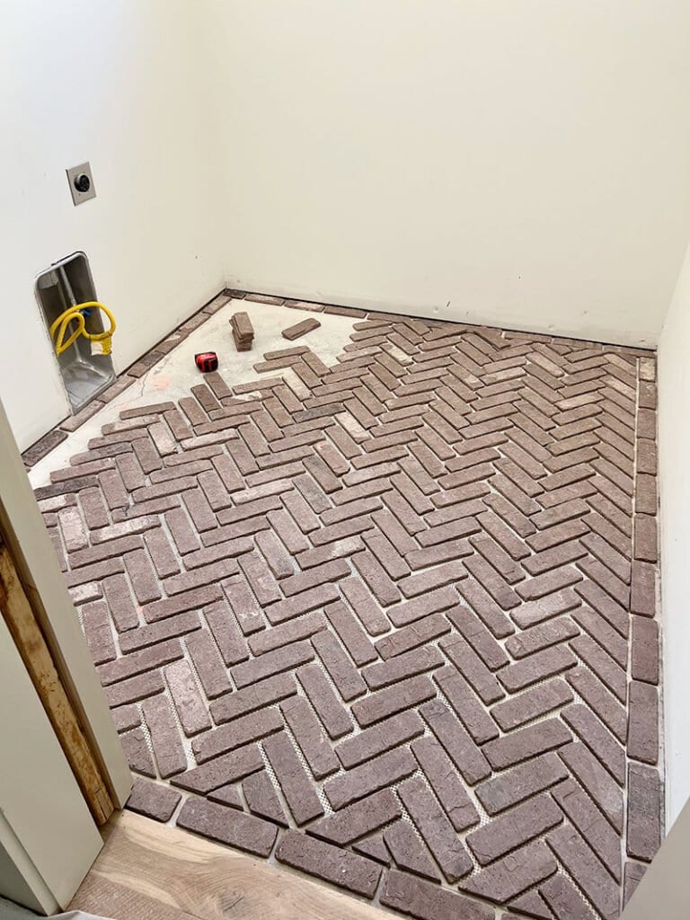 herringbone brick floor installation