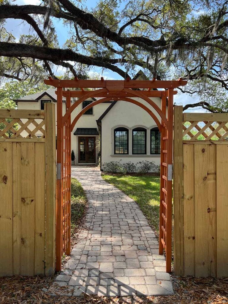 arched wood arbor on a fence