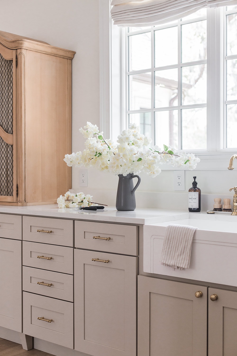 white faux cherry blossoms on kitchen counter