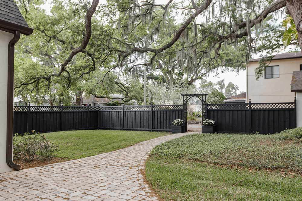 black backyard fence with a lattice top