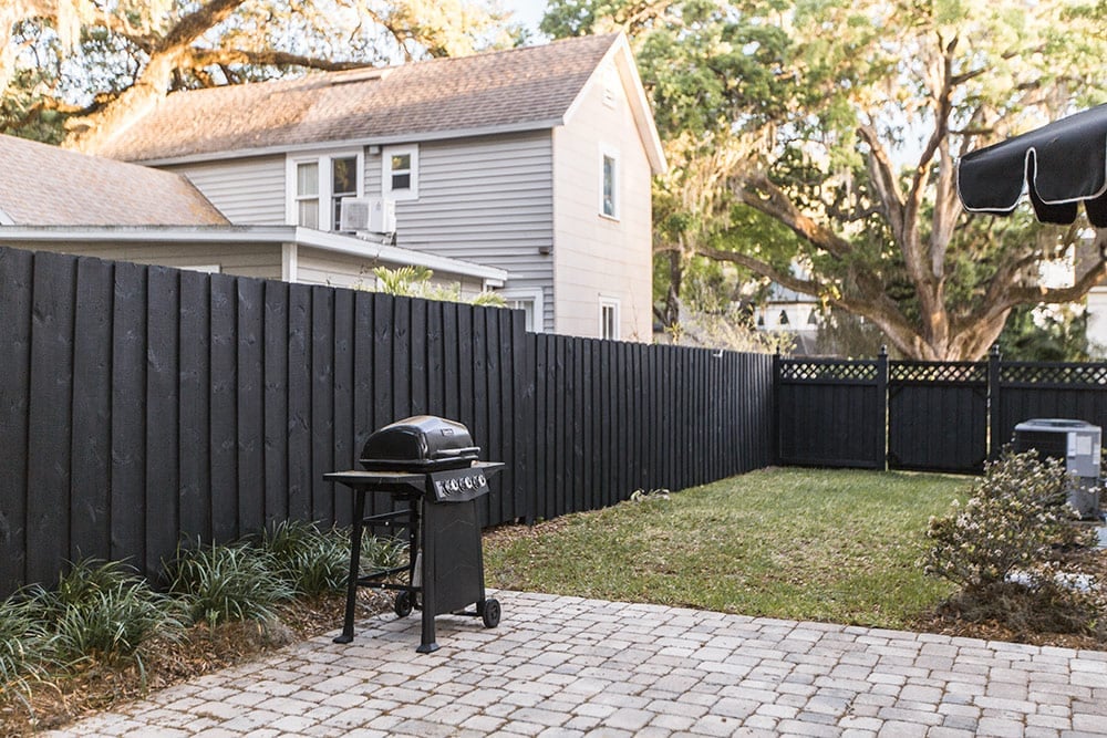 Black wood fence and DIY arbor reveal Jenna Sue Design