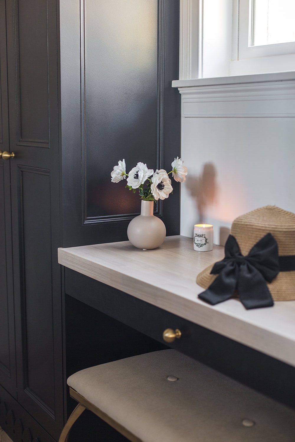 black closet vanity desk with white anemone flowers
