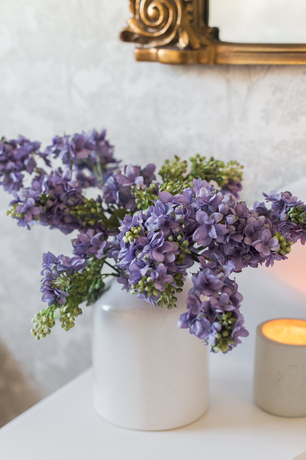 closeup of faux lilacs on bathroom counter