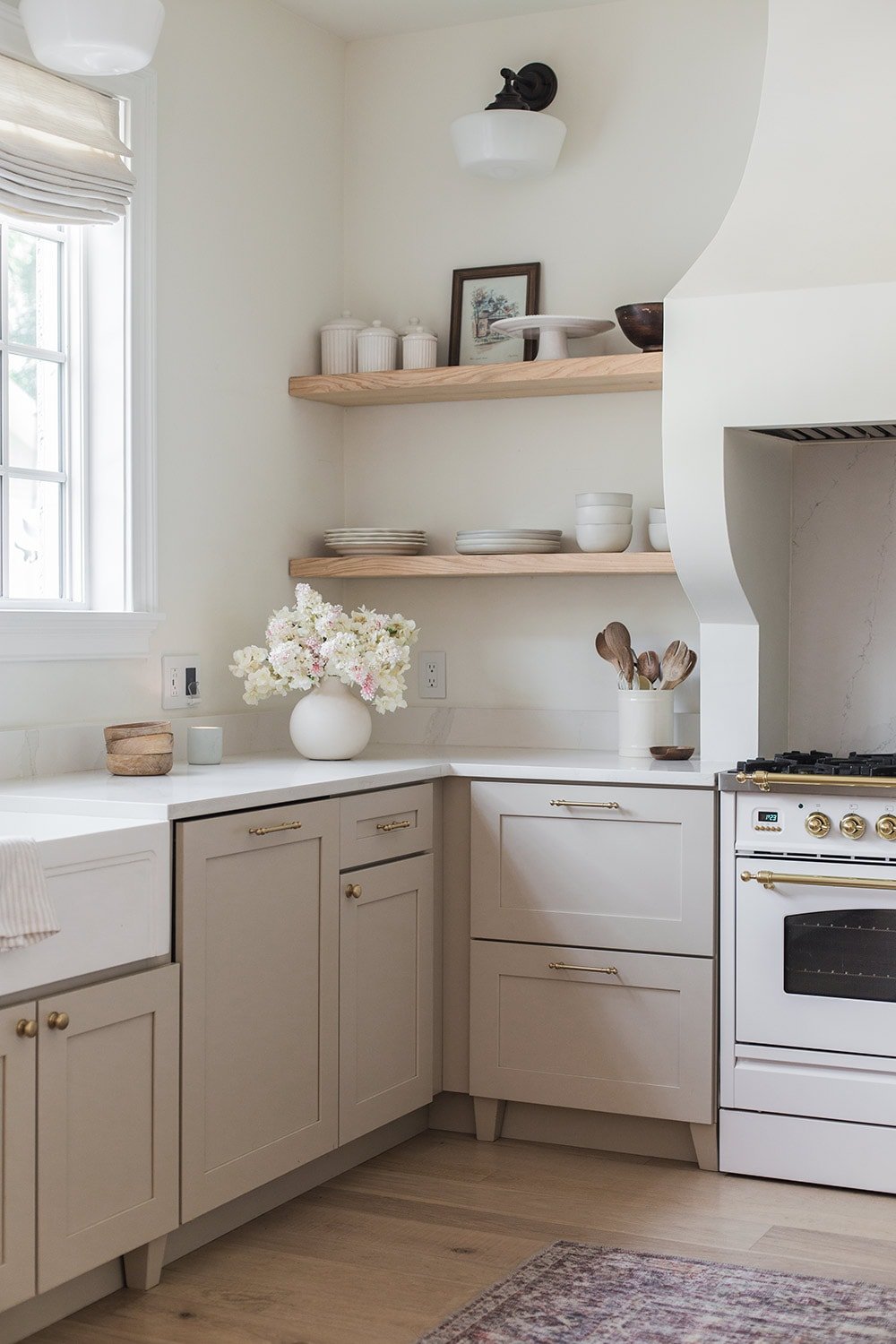 light neutral kitchen with white flowers in vase on counter