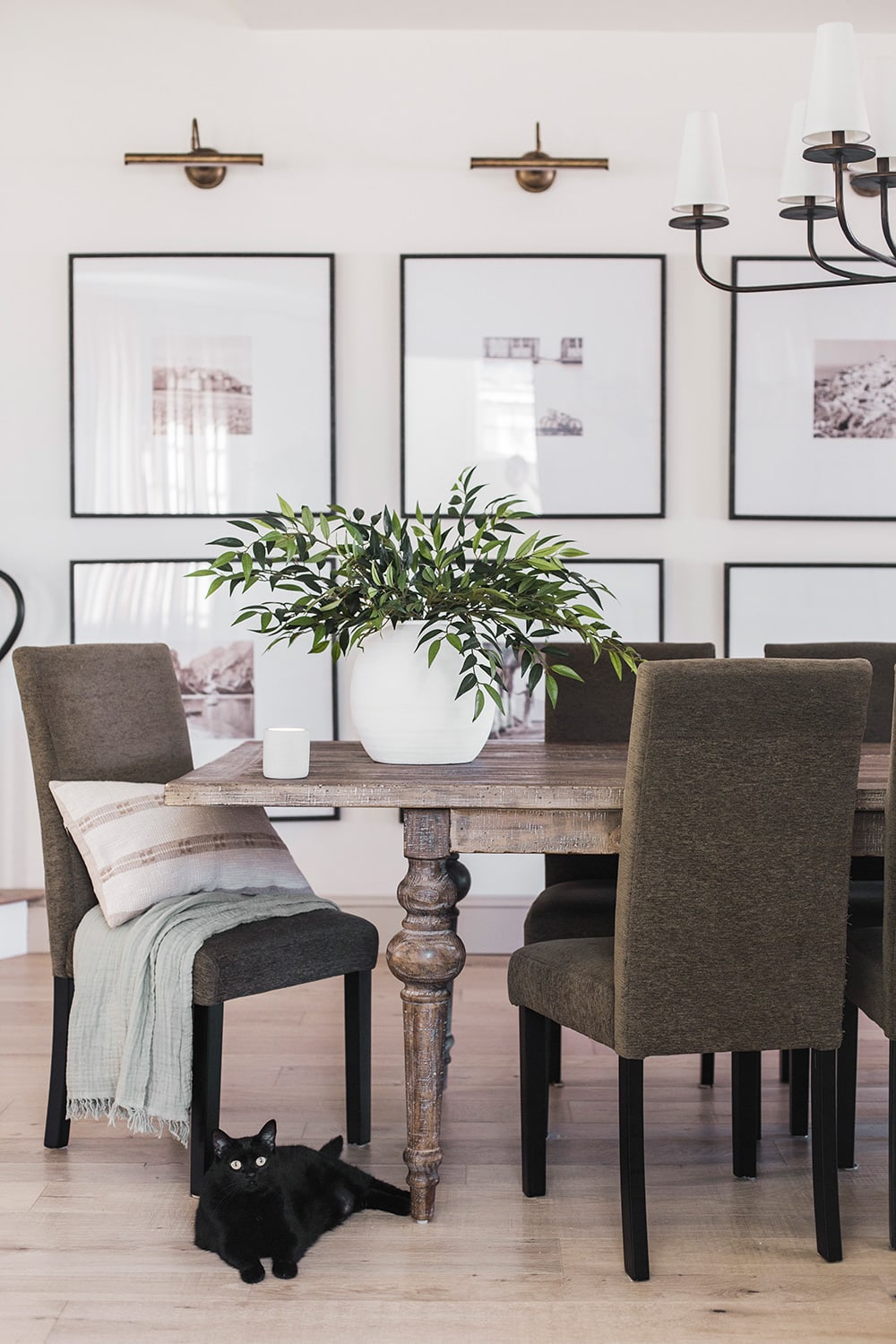 dining room with green faux similax stems in vase