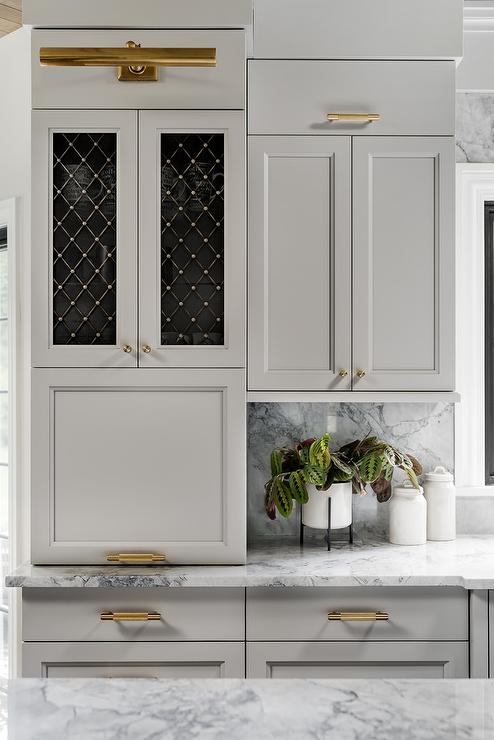 gray kitchen cabinets with brass picture light