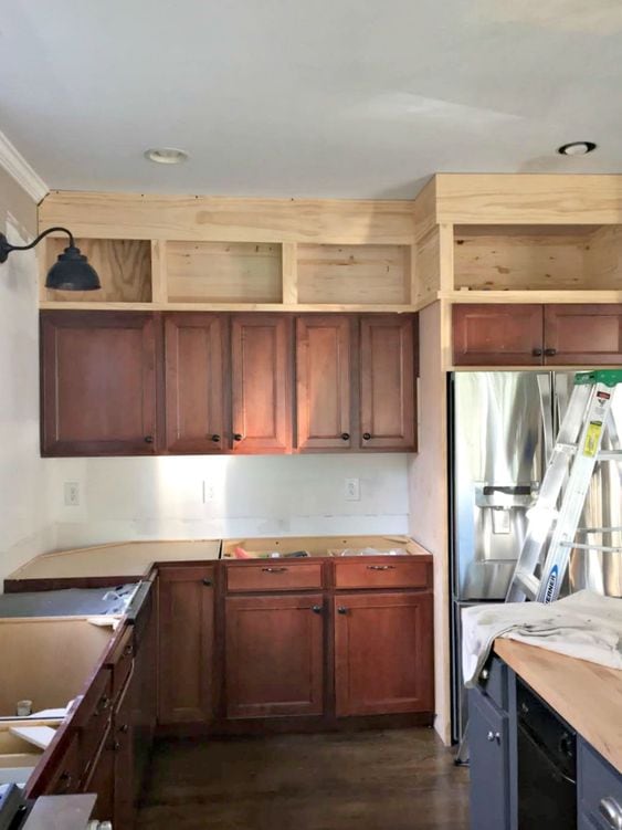 process shot with kitchen with diy wood upper cabinets