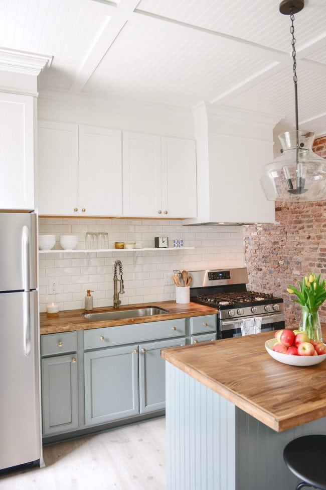 kitchen with light blue lower cabinets and white uppers