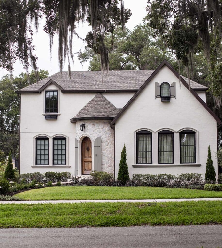 exterior of french country style home in florida with landscaping