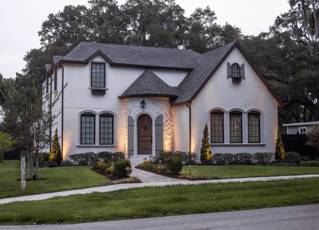 exterior of modern french country style house with landscape lighting