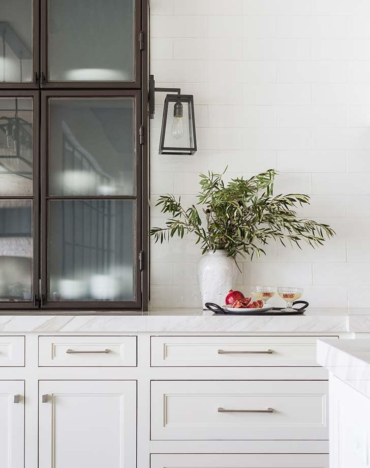 kitchen with white cabinets and a metal cabinet on counter