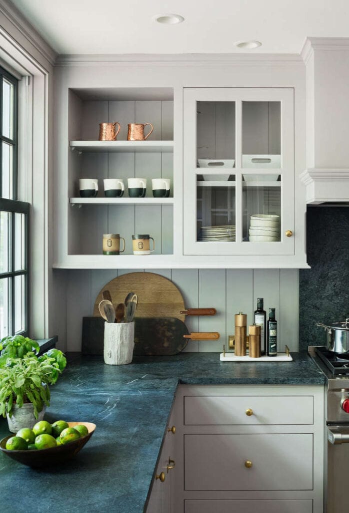 light gray kitchen cabinets with open shelving and a glass door