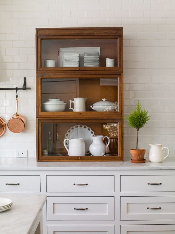 kitchen with white cabinets and antique wood bookcase