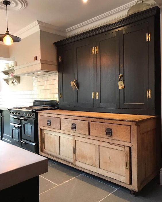 kitchen with black cabinets and antique hutch cabinet