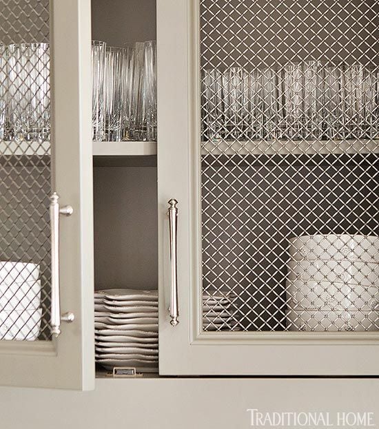 closeup of kitchen cabinets with wire mesh panel