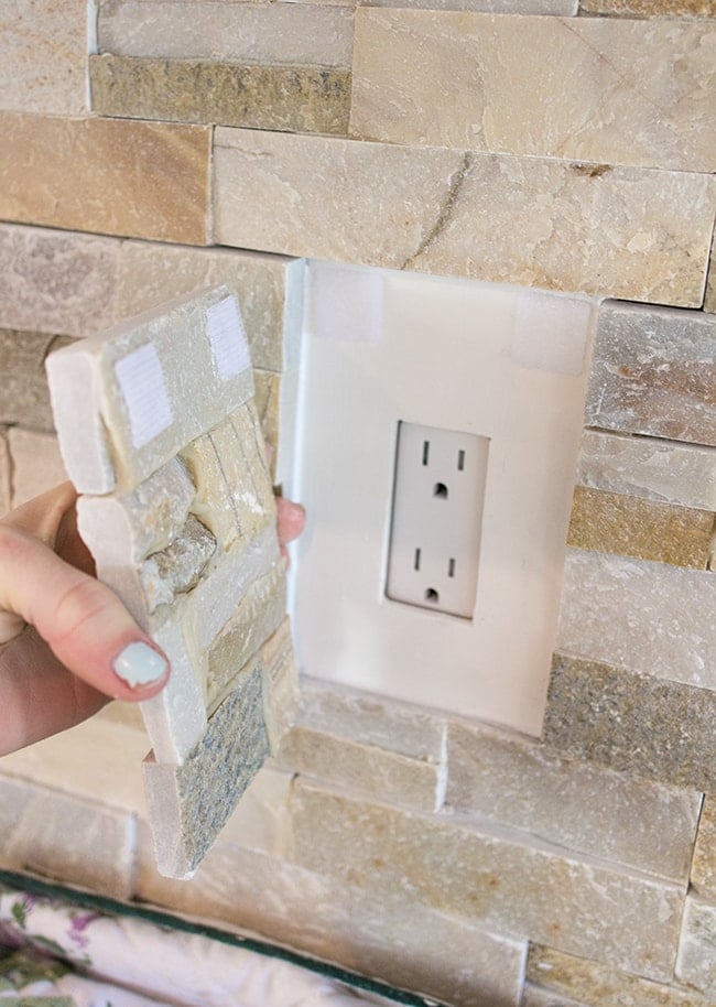 kitchen outlet hidden underneath a removable piece of ledgestone tile