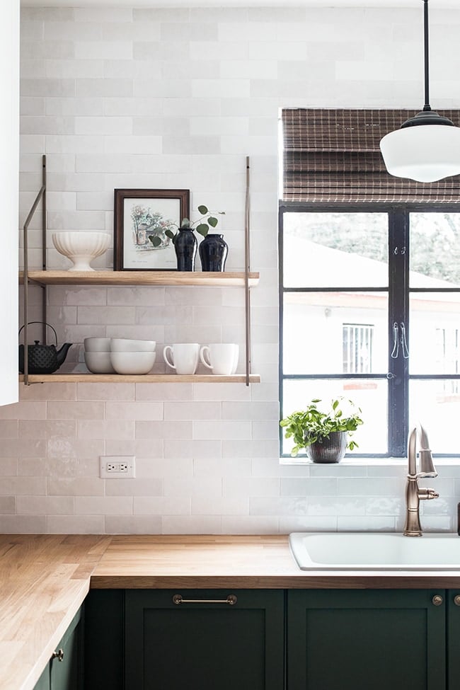 kitchen with white subway tile, horizontal outlet and dark green cabinets