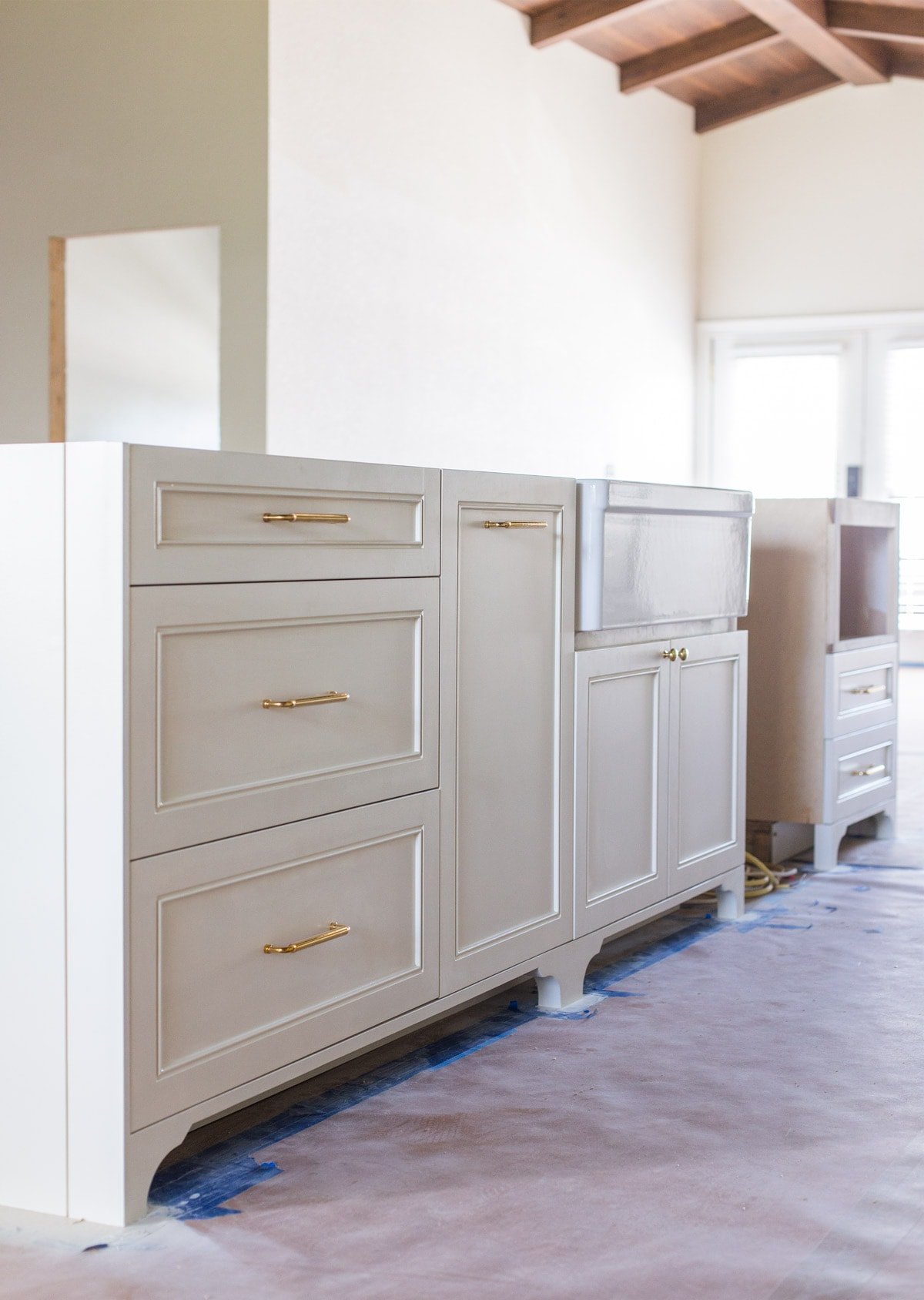 bm creamy white island cabinets with custom toe kick valance